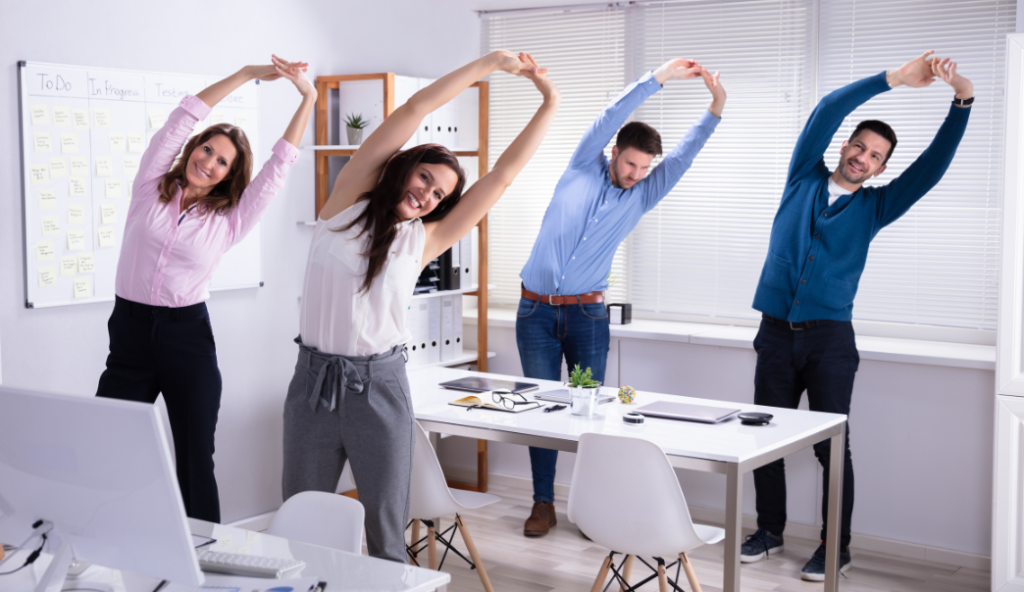 Employees stretching at their desks