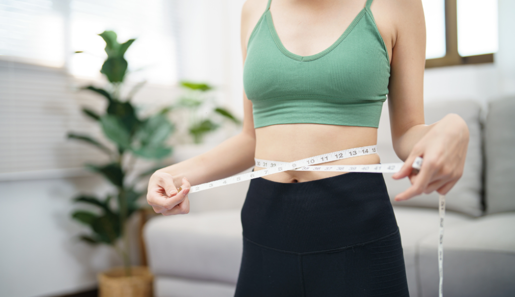 Women using measuring tape to gauge weight loss